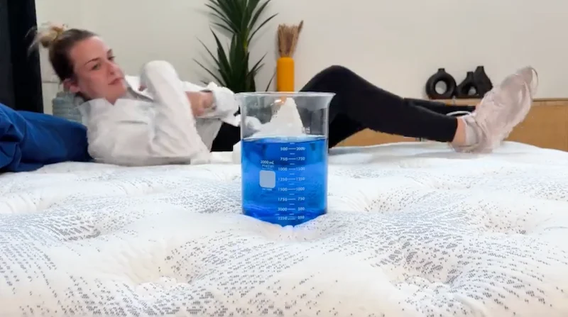 Testing motion isolation on the Serta Perfect Sleeper Cascade Range Medium mattress with a beaker of water