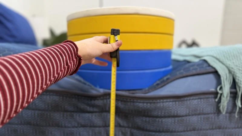 Our tester measures the deflection of weight plates along the edge of the Brooklyn Bedding Signature Hybrid Mattress