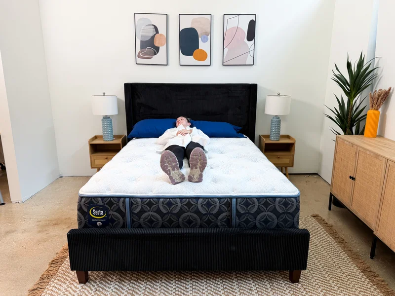 A tester lying on her back on the Serta Perfect Sleeper Cascade Range Medium mattress