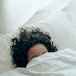 unrecognizable person sleeping under blanket 4546117 1