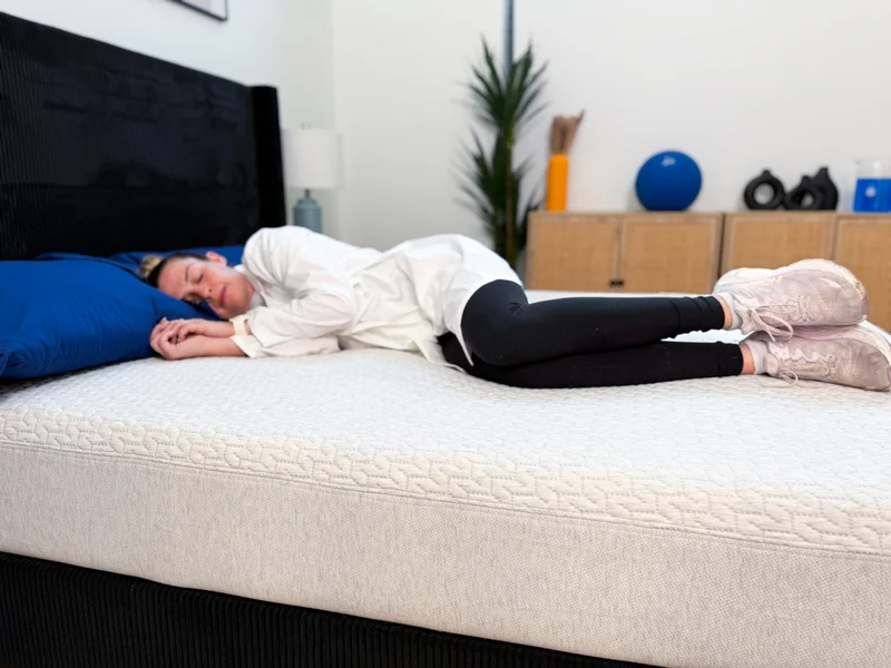 A tester lies on her side on the Tuft and Needle Original mattress