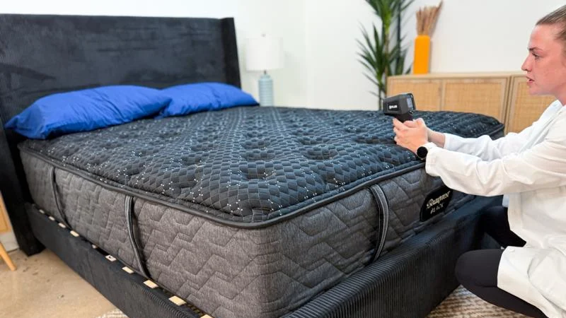 Our product tester takes thermal readings of the Beautyrest Black mattress.