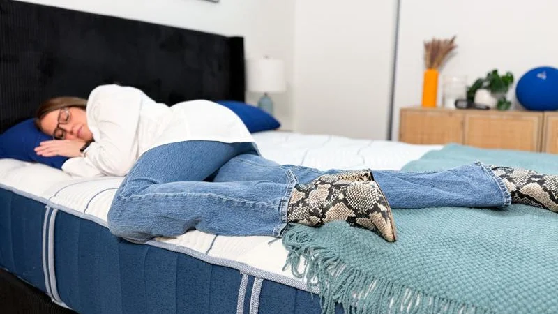 Our tester side-sleeping on the Bear Elite Hybrid Mattress