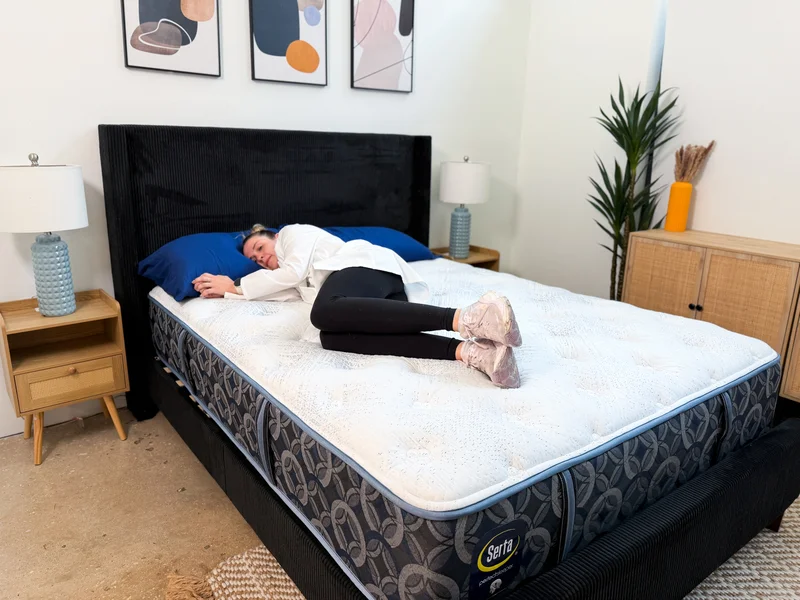 Tester side sleeping on the Serta Perfect Sleeper Cascade Range Medium mattress