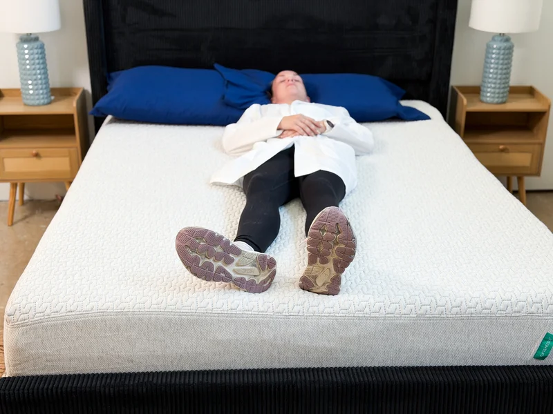 A tester lies on her back on the Tuft and Needle Original mattress