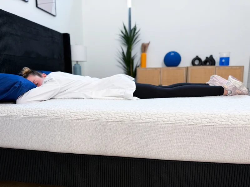A tester lies on her stomach on the Tuft and Needle Original mattress