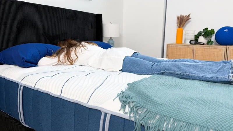 Our tester stomach-sleeping on the Bear Elite Hybrid Mattress