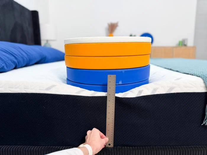 measuring weight plates on the edge of the nectar classic memory foam mattress