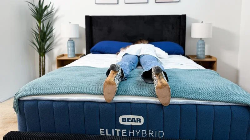 Our tester stomach-sleeping on the Bear Elite Hybrid Mattress