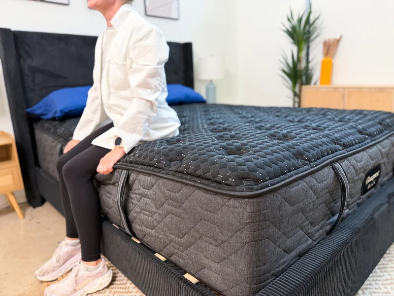 Product expert testing the seated edge support of the Beautyrest Black.