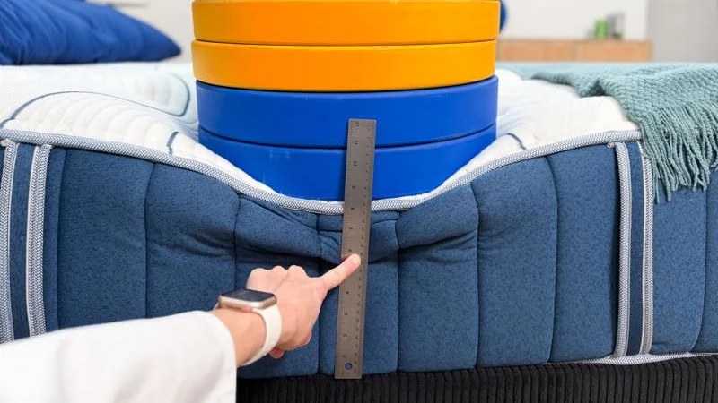 Measuring the deflection of weight plates along the edge of the Bear Elite Hybrid Mattress
