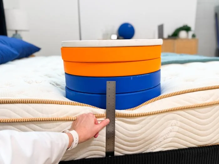 measuring weight plates on the edge of the saatva classic mattress