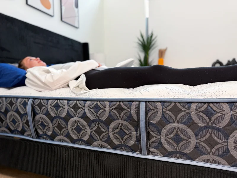 Testing edge support on the Serta Perfect Sleeper Cascade Range Medium mattress by lying down near the perimeter